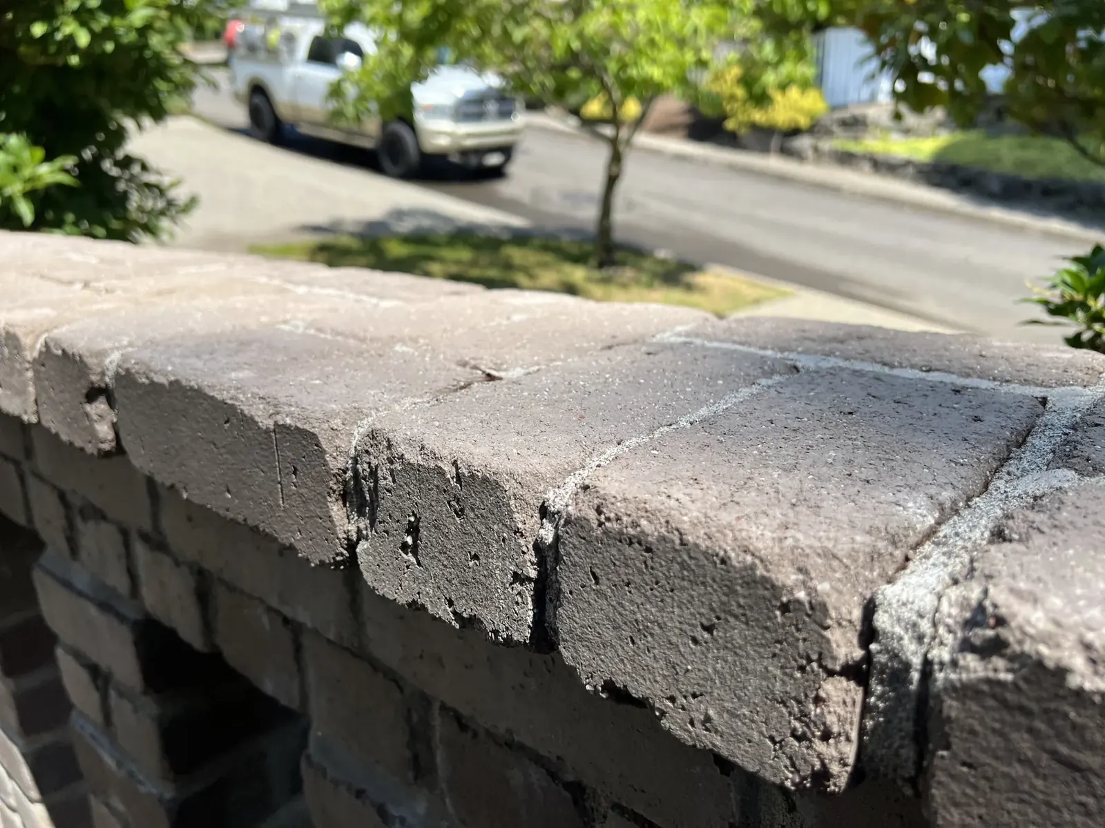 Weathered brick wall cap after cleaning with existing chipped edges visible