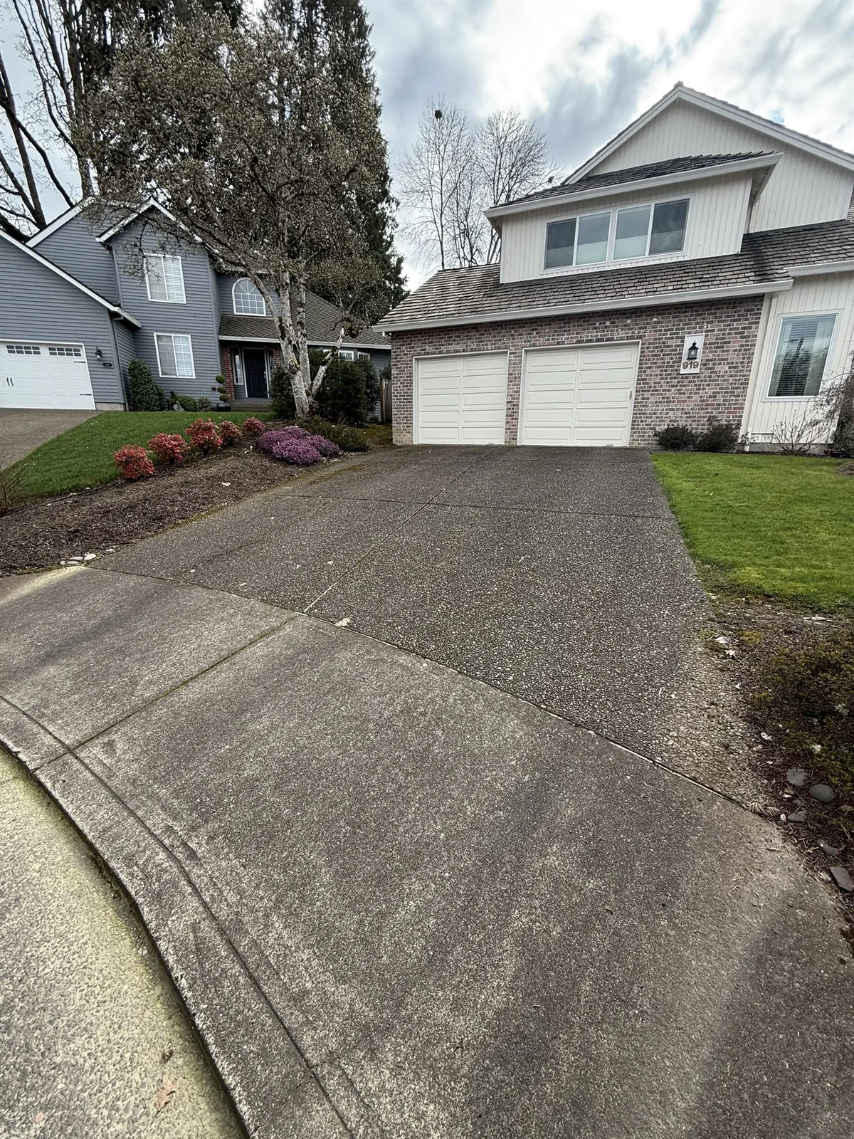 Wide view of Beaverton exposed aggregate driveway before pressure washing