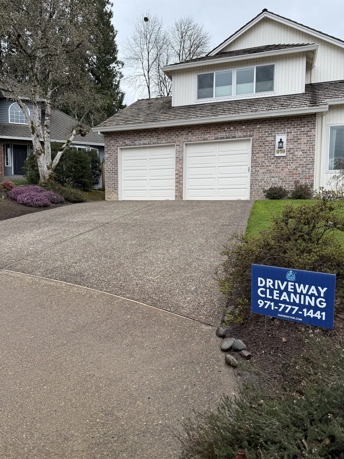 Finished Beaverton exposed aggregate driveway cleaning project with Suds Doctor yard sign