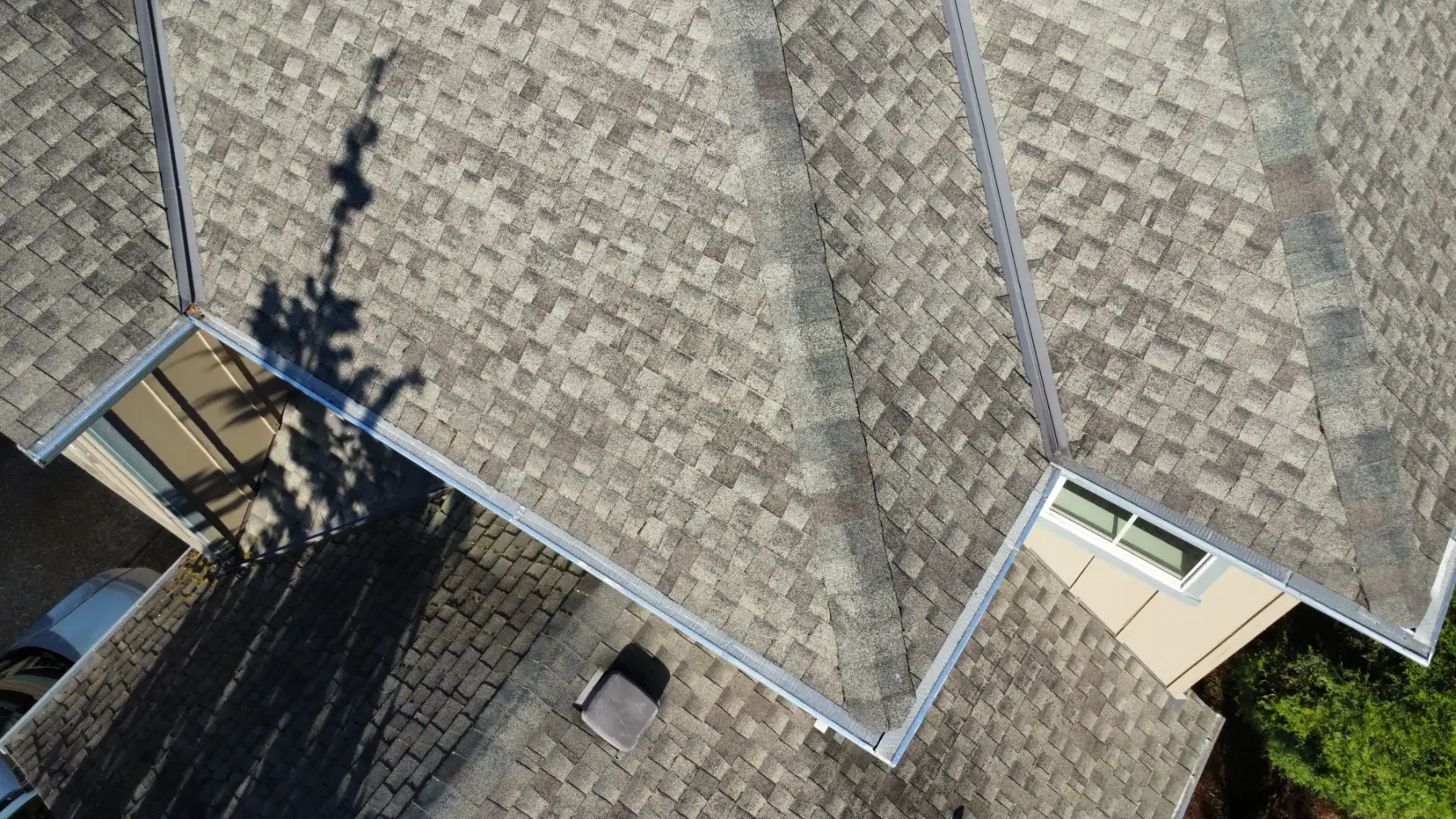 Drone view of a mostly clean Beaverton asphalt shingle roof before selective moss treatment