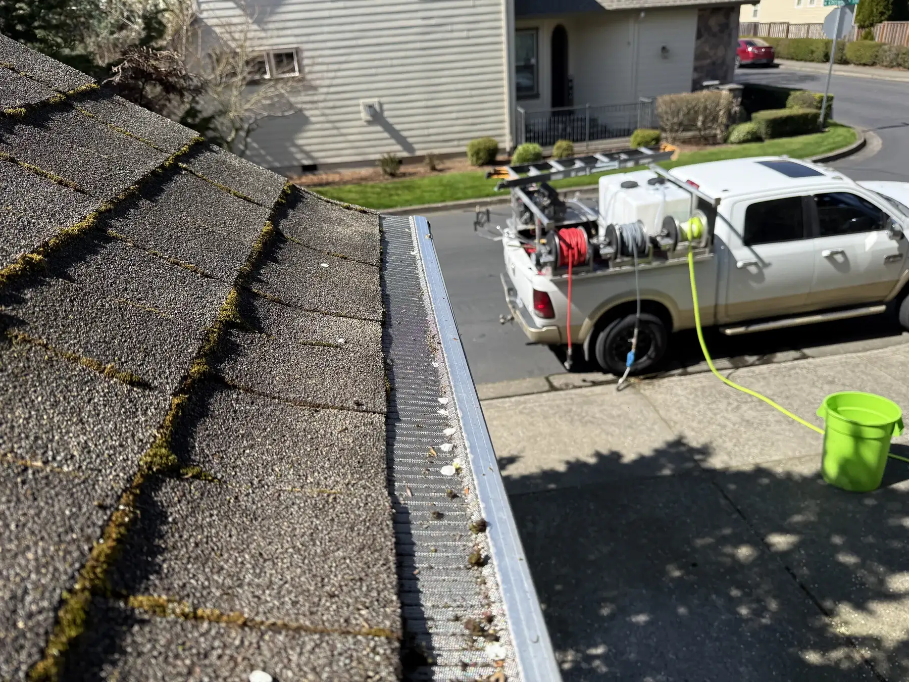 Suds Doctor truck setup below a Beaverton roof during partial roof moss treatment