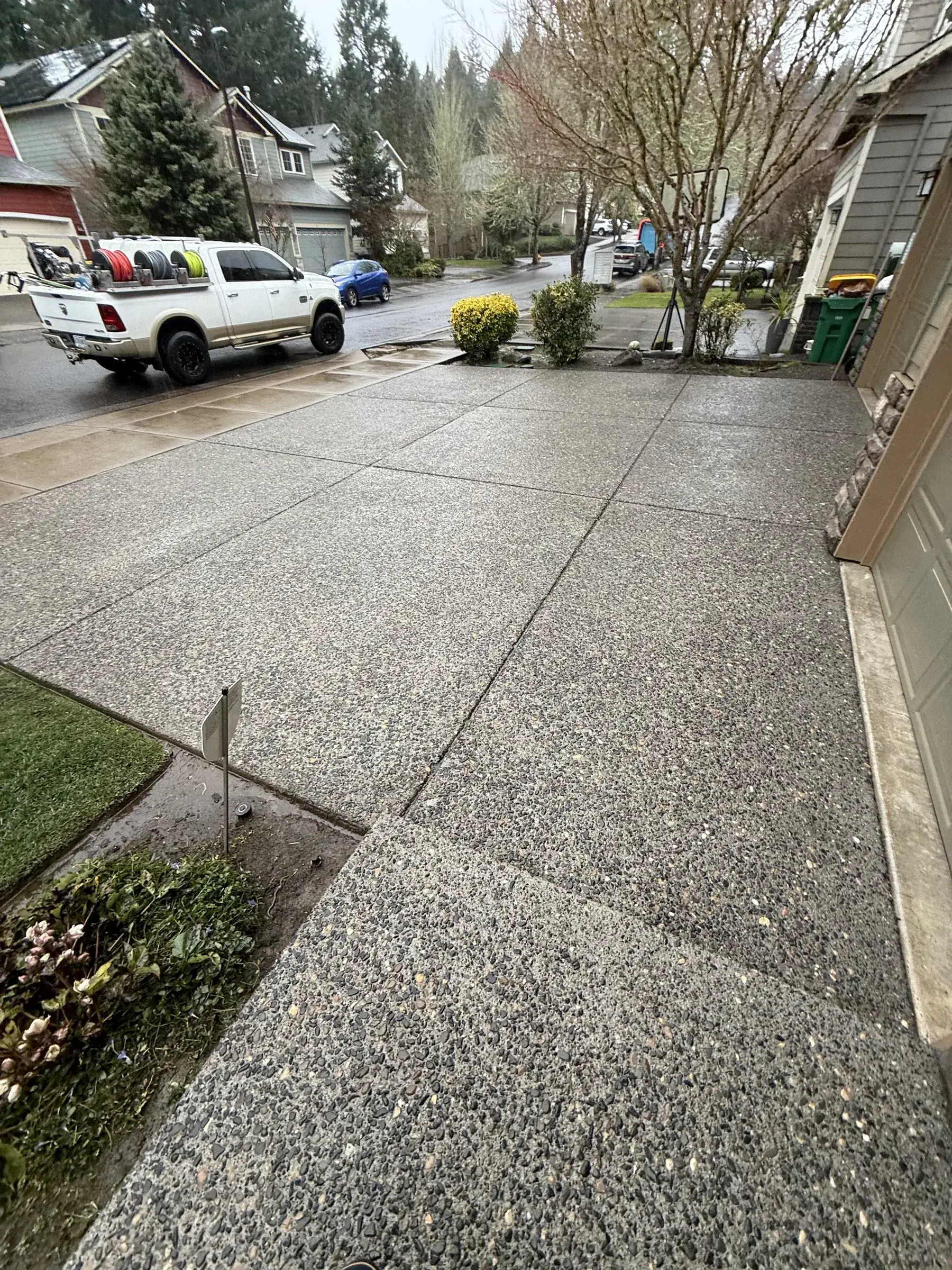 Cleaned exposed aggregate driveway in South Beaverton after rainy-day pressure washing