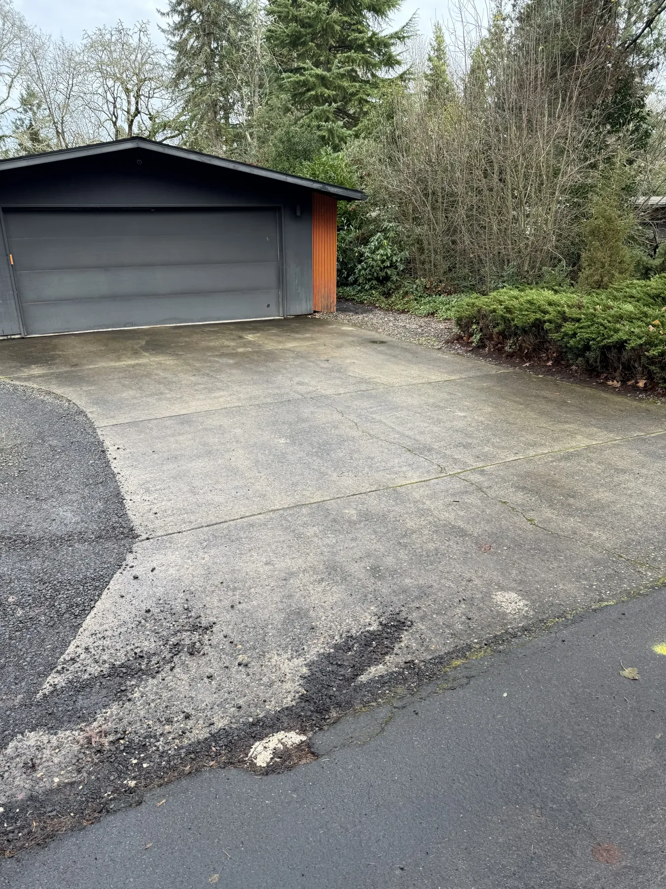 Concrete driveway near a detached garage during a Cedar Mill pressure washing project