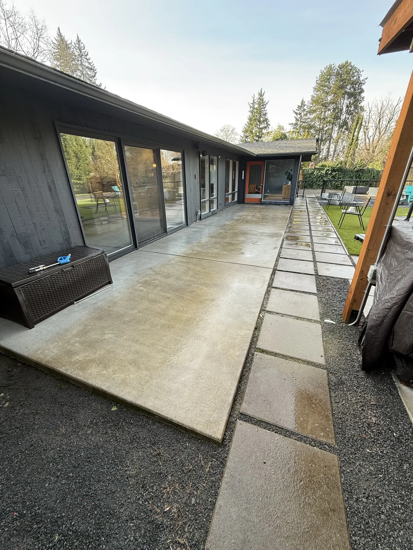 Cleaned long concrete patio beside a Cedar Mill home after pressure washing