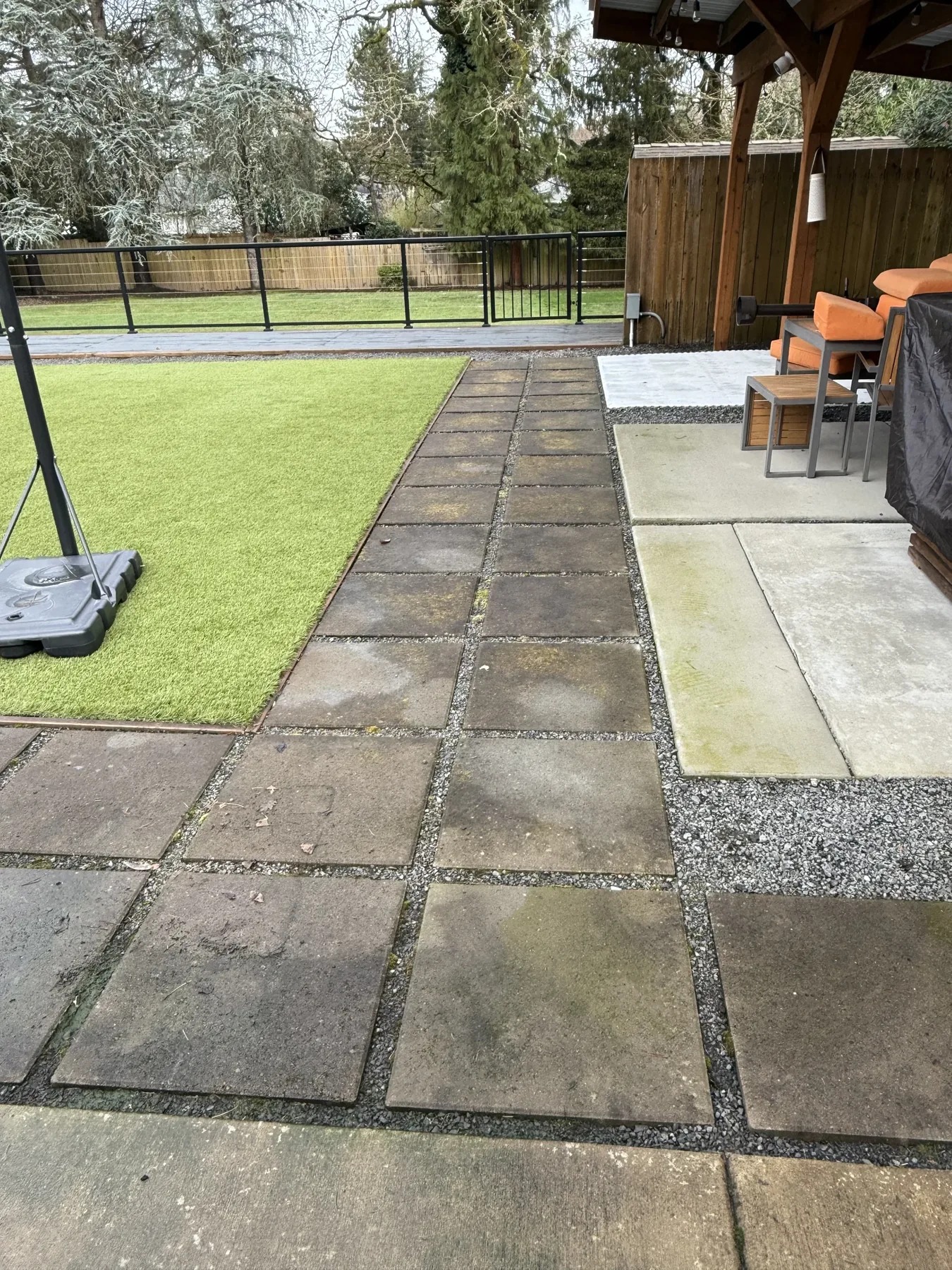 Square patio slabs and artificial turf at a Cedar Mill backyard cleaning project