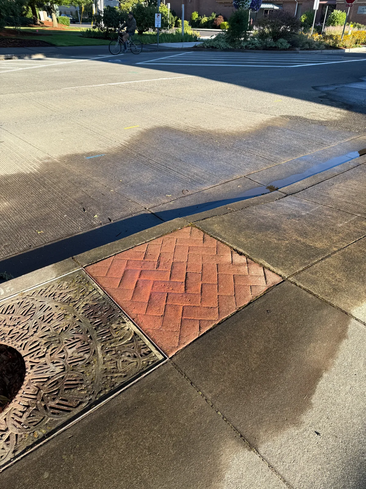 Wet NE 2nd Avenue sidewalk and street area after early-morning chalk cleaning