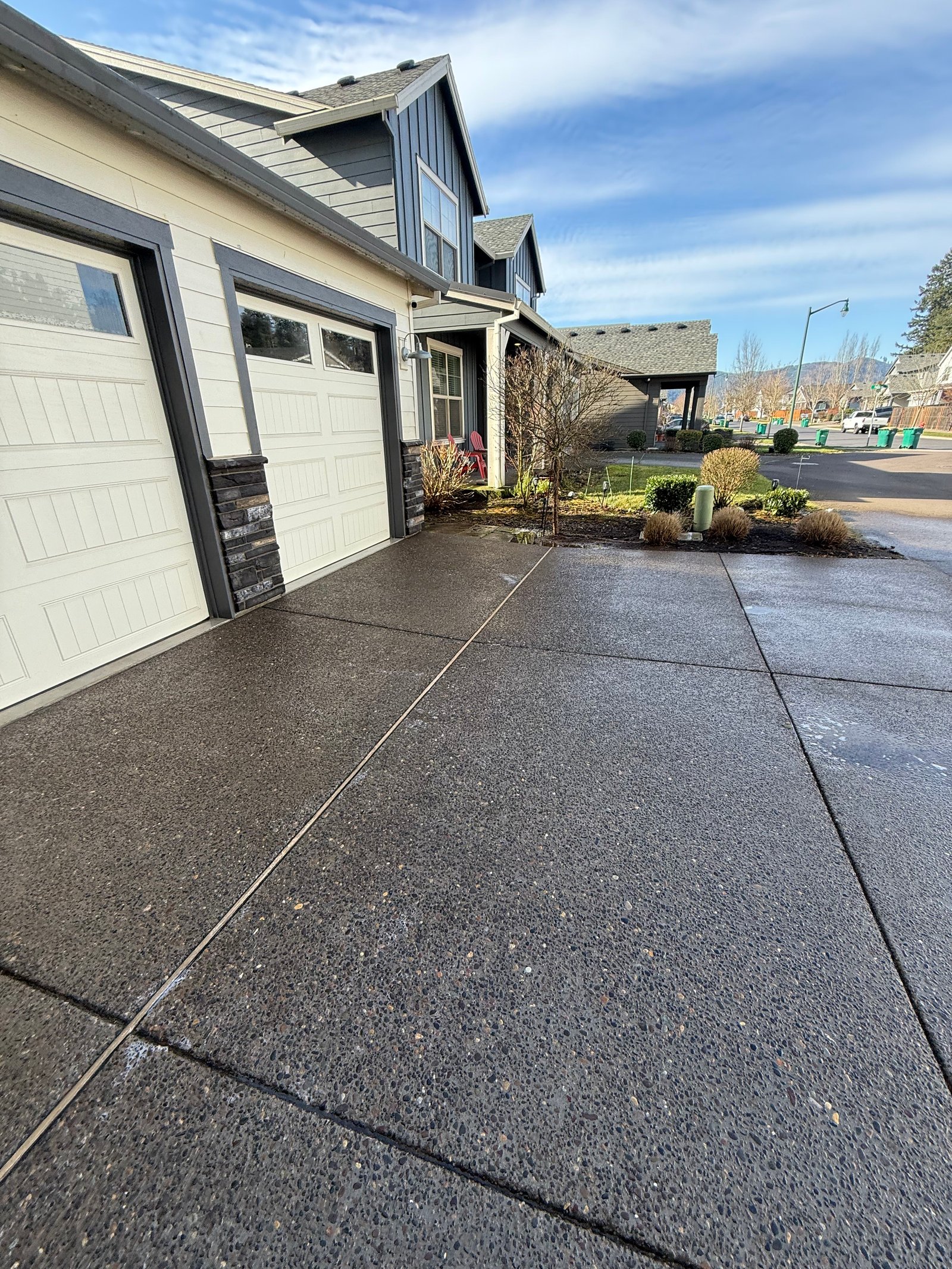 Driveway concrete in Oregon where shaded areas can collect moss, algae, and wet-weather buildup