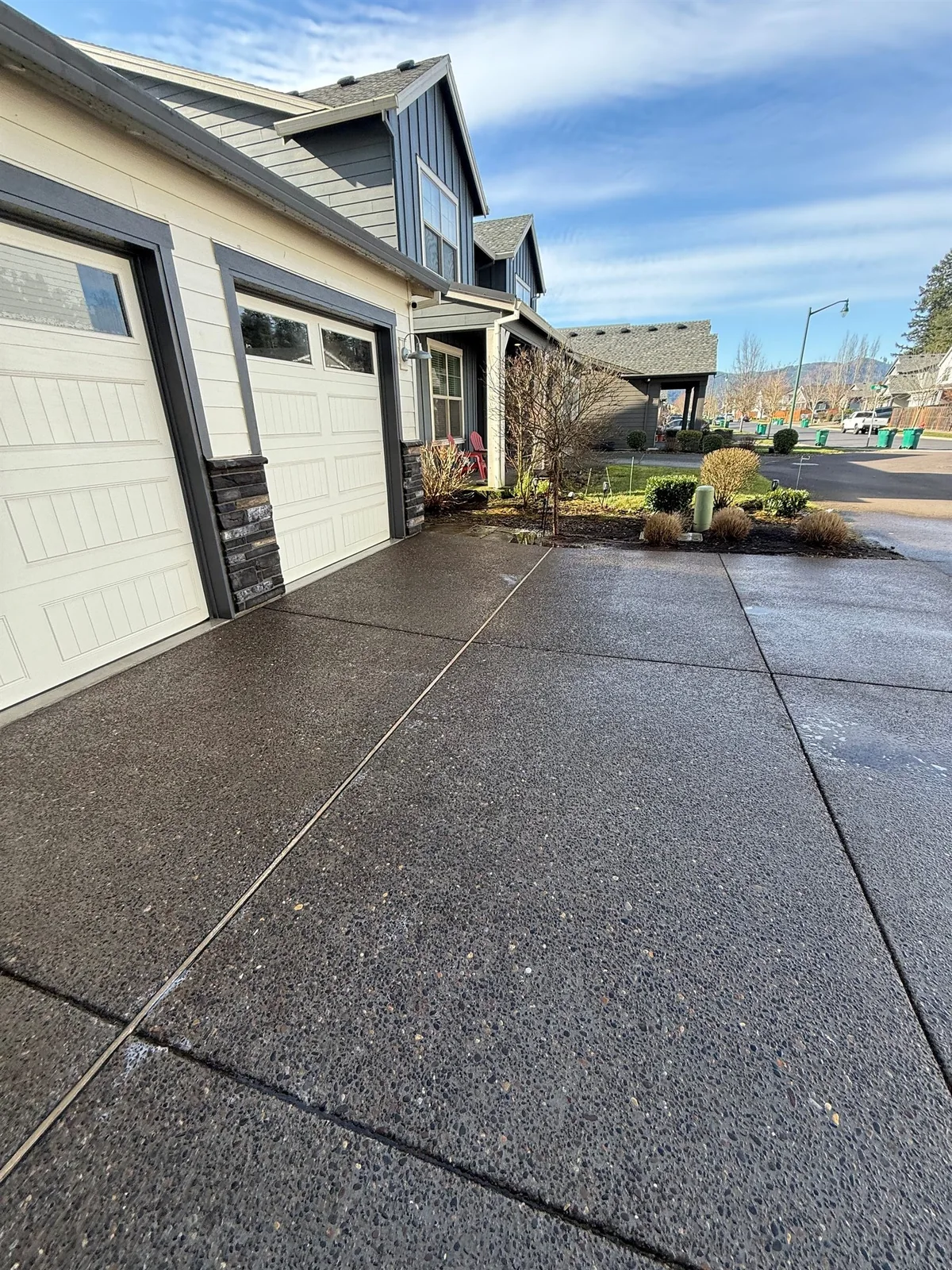 Driveway concrete in Oregon where shaded areas can collect moss, algae, and wet-weather buildup