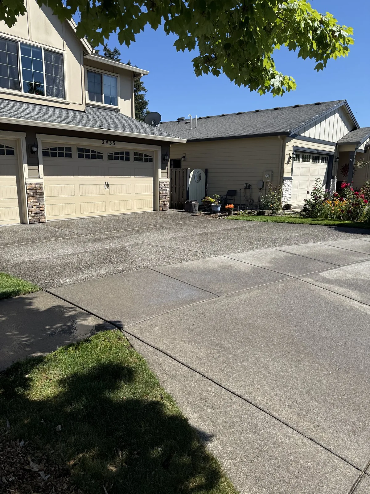Clean residential driveway after controlled pressure washing in western Washington County