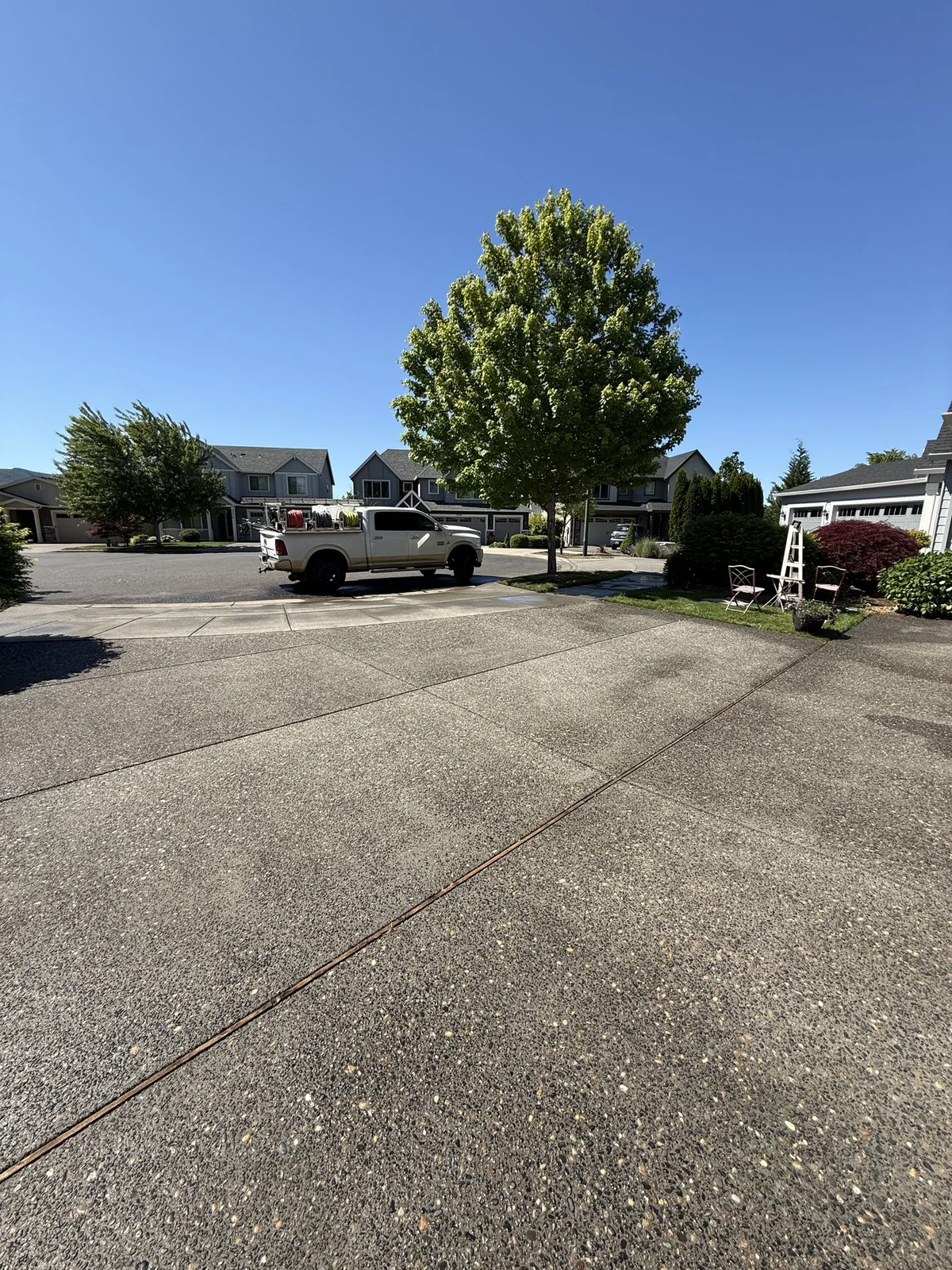Wide view of Forest Grove concrete driveway before pressure washing