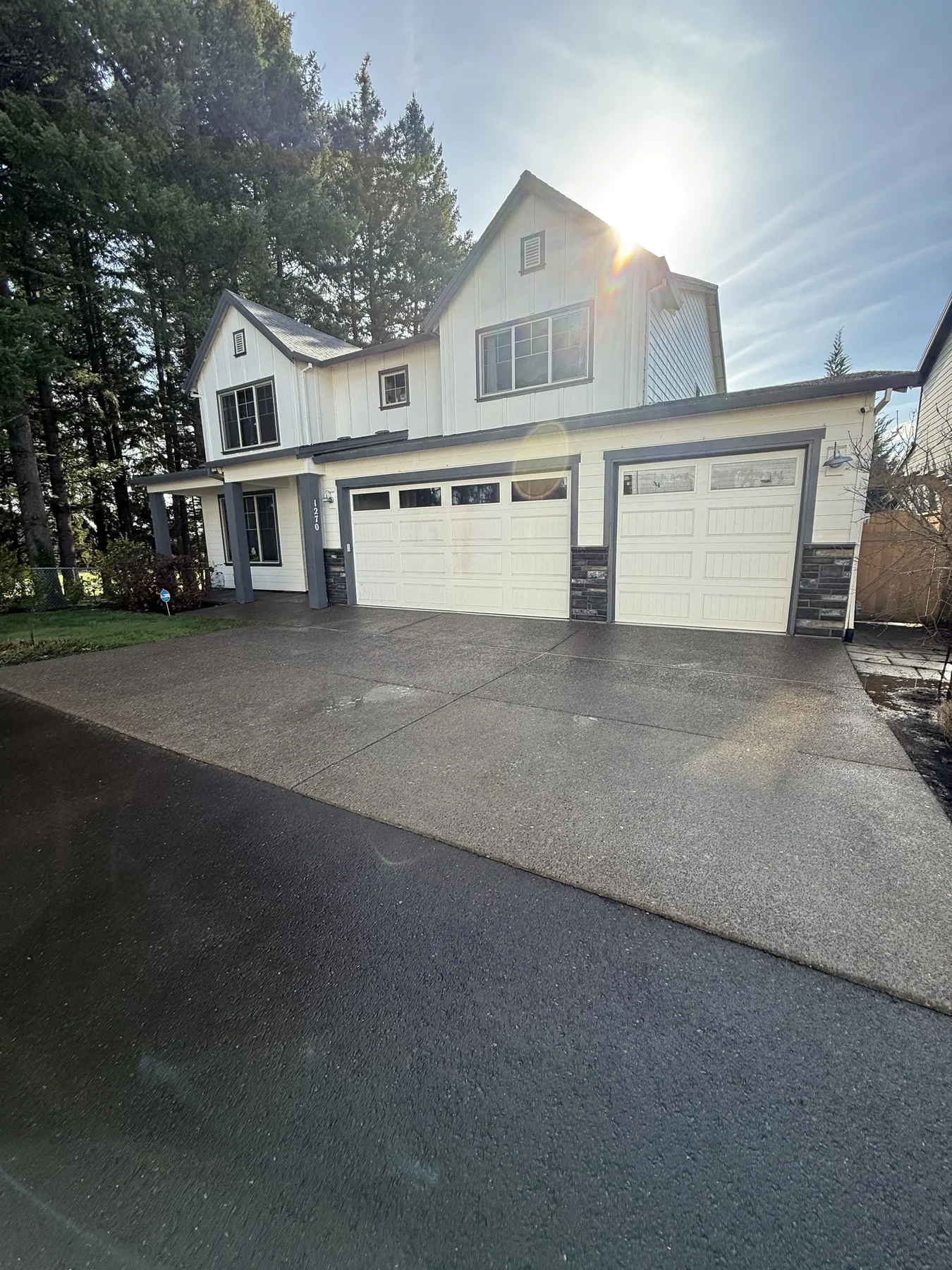 Wet finished concrete driveway after pressure washing in Forest Grove Oregon