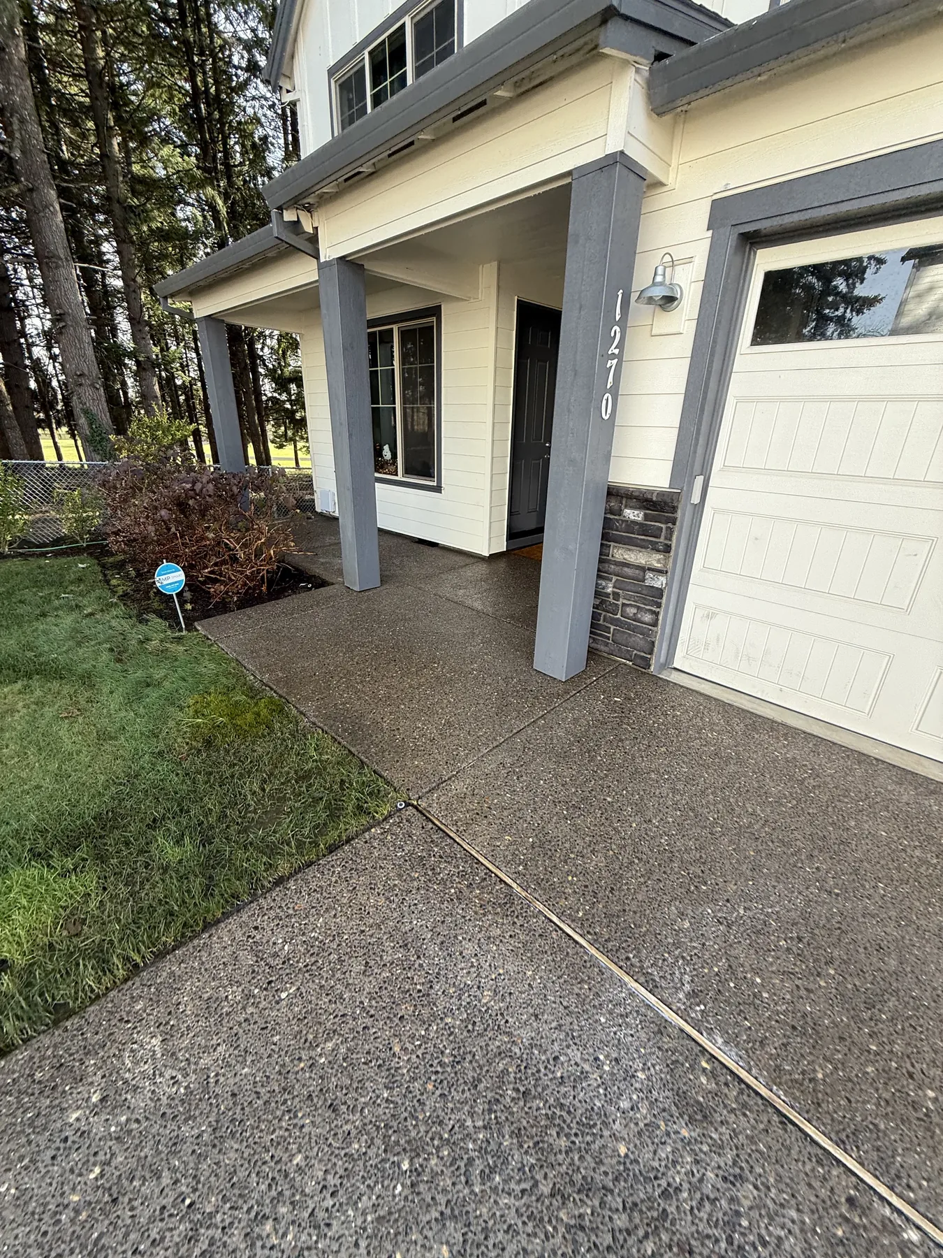 Cleaned Forest Grove driveway entry walkway and porch approach after pressure washing
