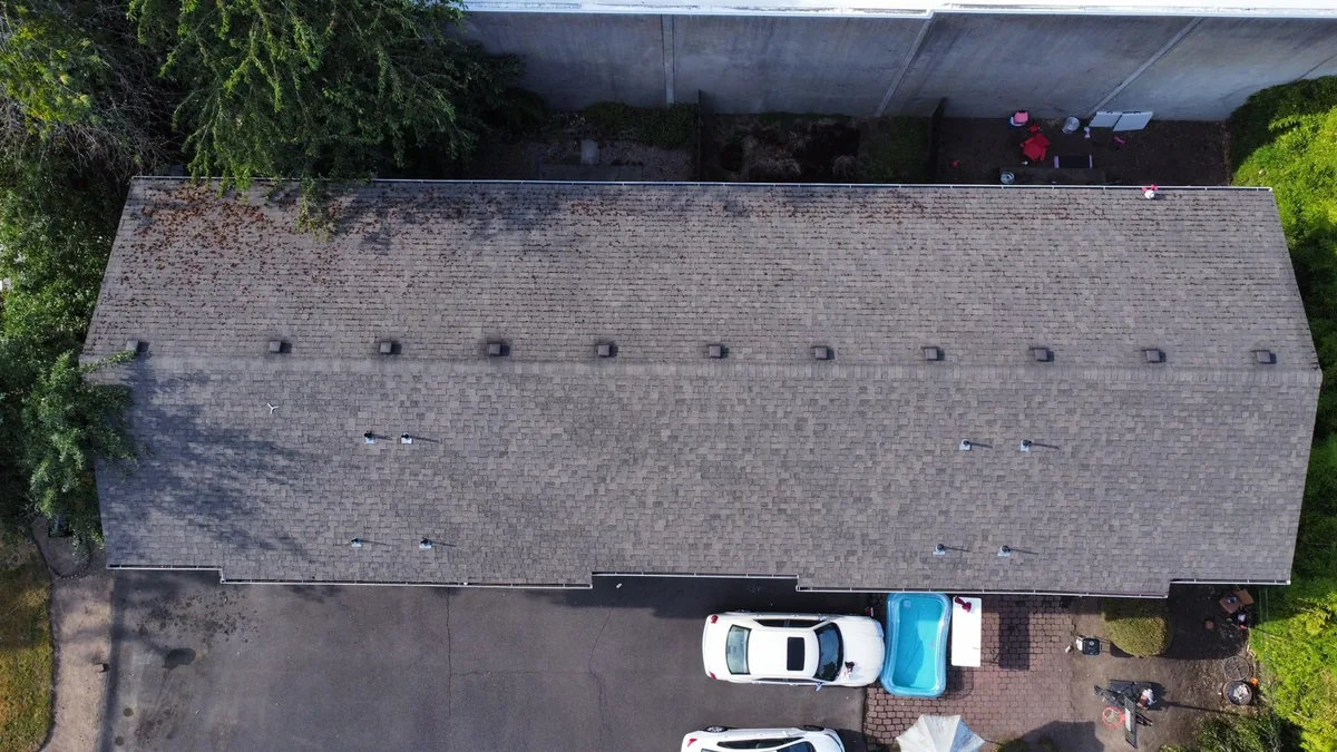 Aerial view of moss on a Forest Grove fourplex roof before cleaning