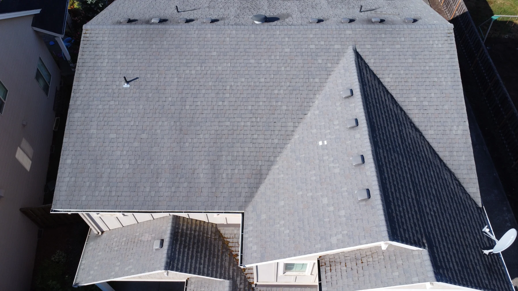 Finished asphalt shingle roof at a Forest Grove house after roof cleaning and moss treatment
