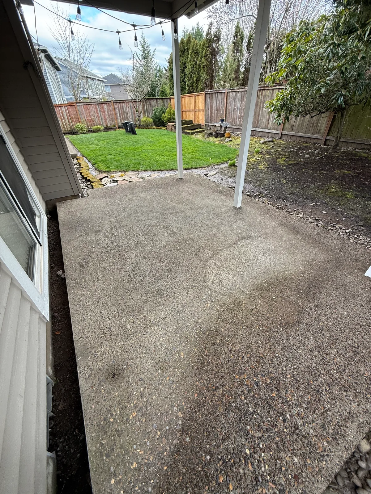 Clean covered patio walkway after pressure washing in a Hillsboro backyard