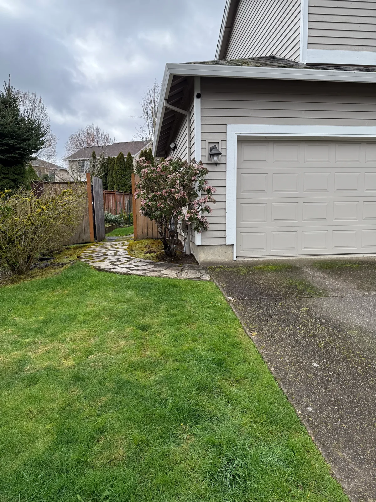 Dark Hillsboro driveway before pressure washing at an HOA home