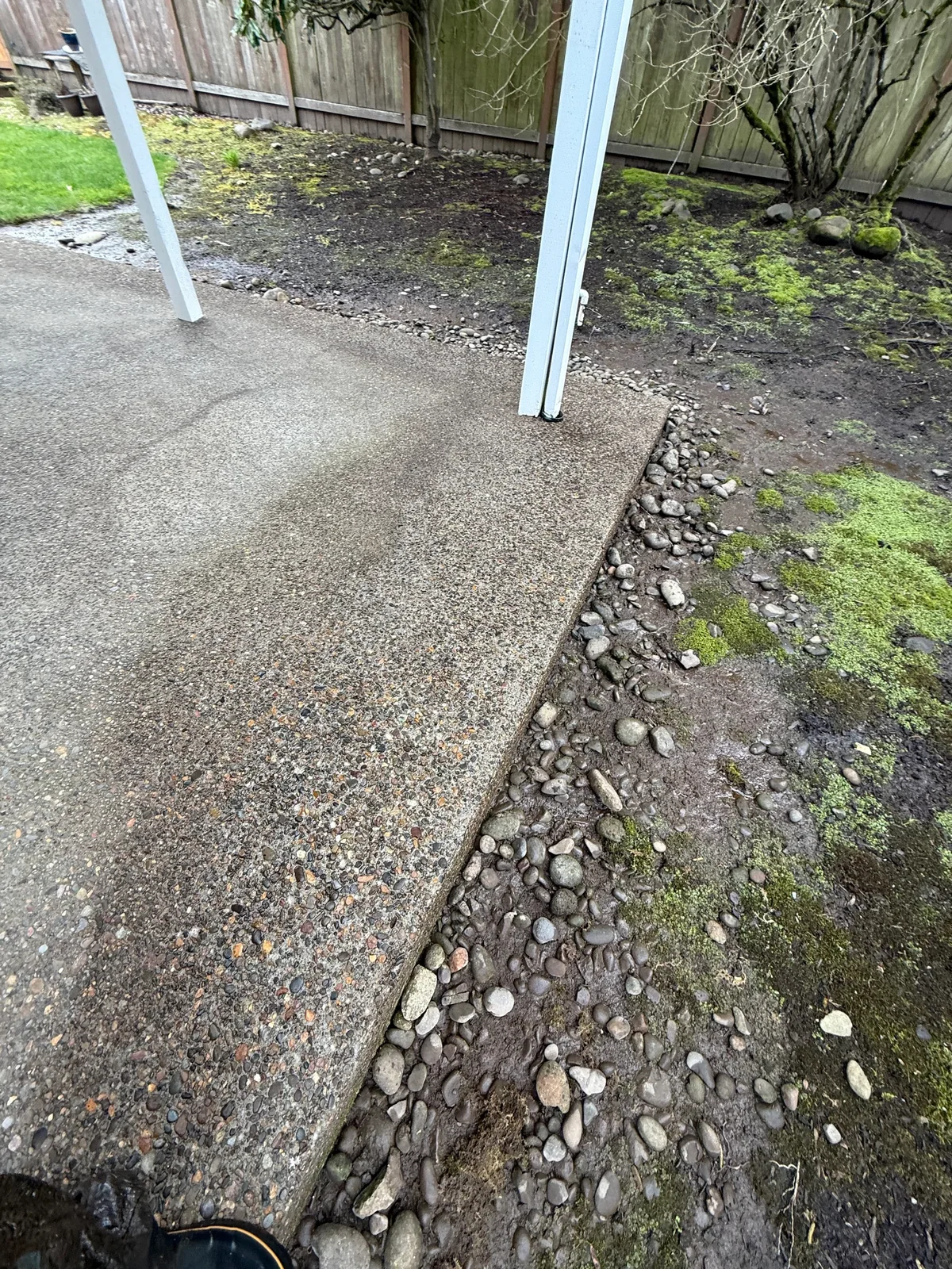 Patio edge after cleaning beside gravel and lawn at a Hillsboro home