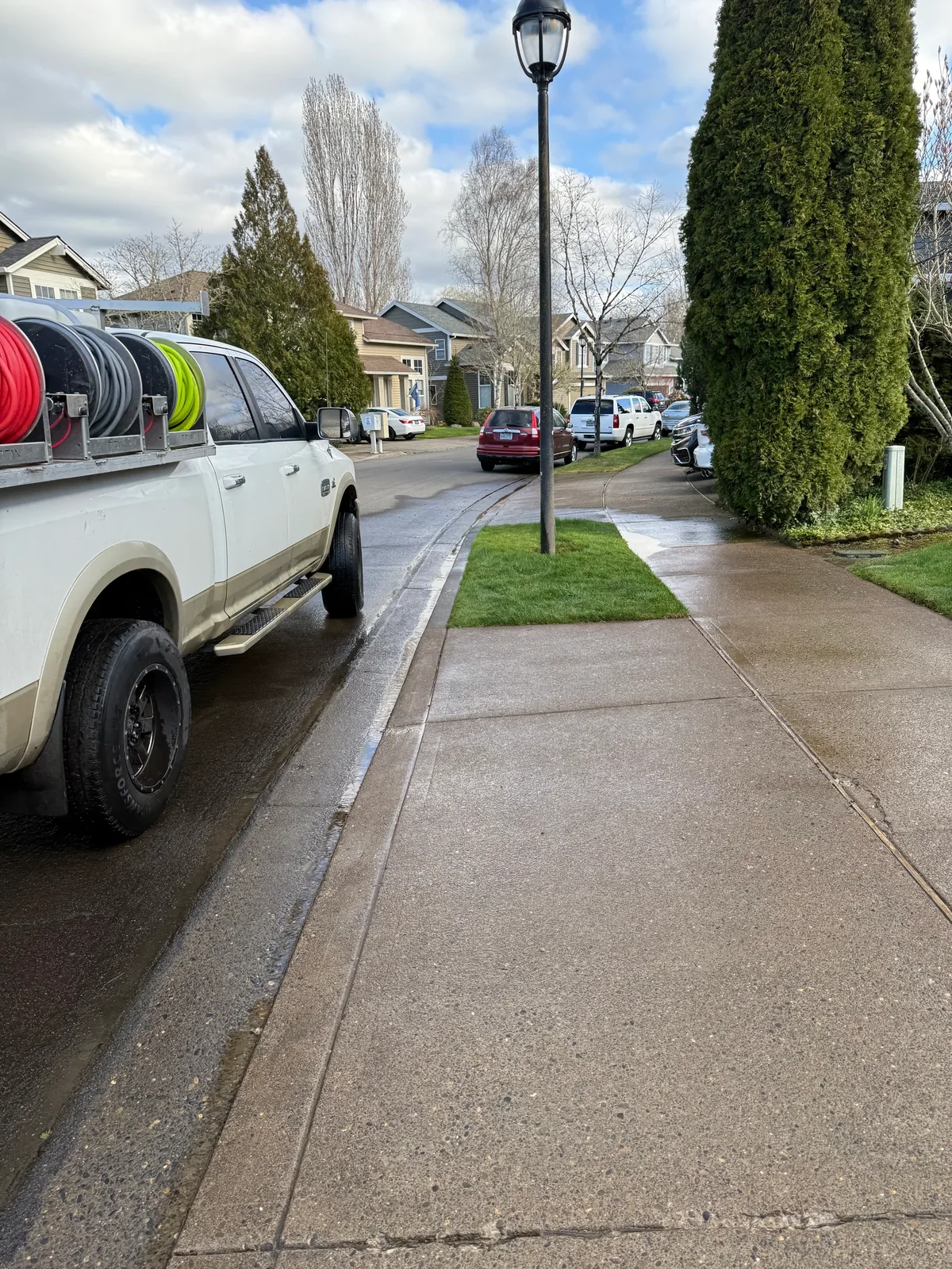 Suds Doctor pressure washing truck beside a cleaned Hillsboro sidewalk