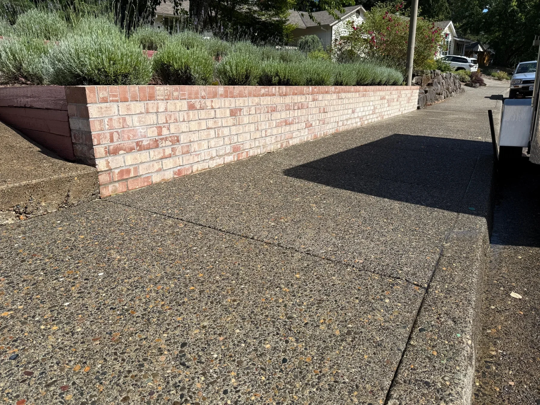 Bright brick retaining wall after black algae and organic buildup were pressure washed in Hillsboro