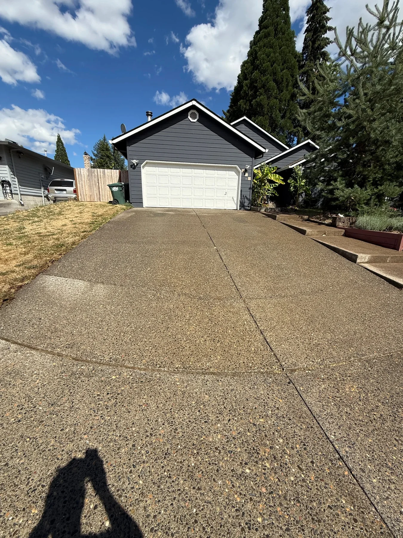 Wide finished view of a clean exposed-aggregate driveway after pressure washing in Hillsboro