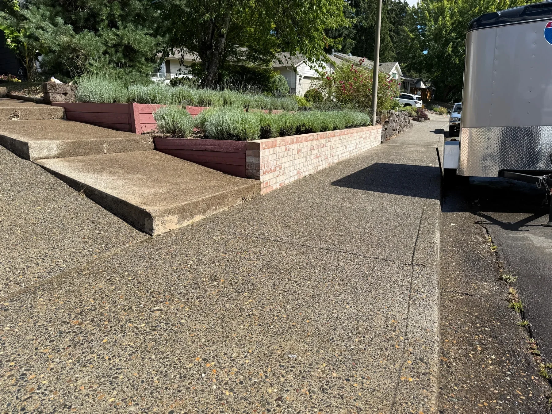Clean Hillsboro driveway and brighter brick retaining wall after pressure washing near McKay Creek