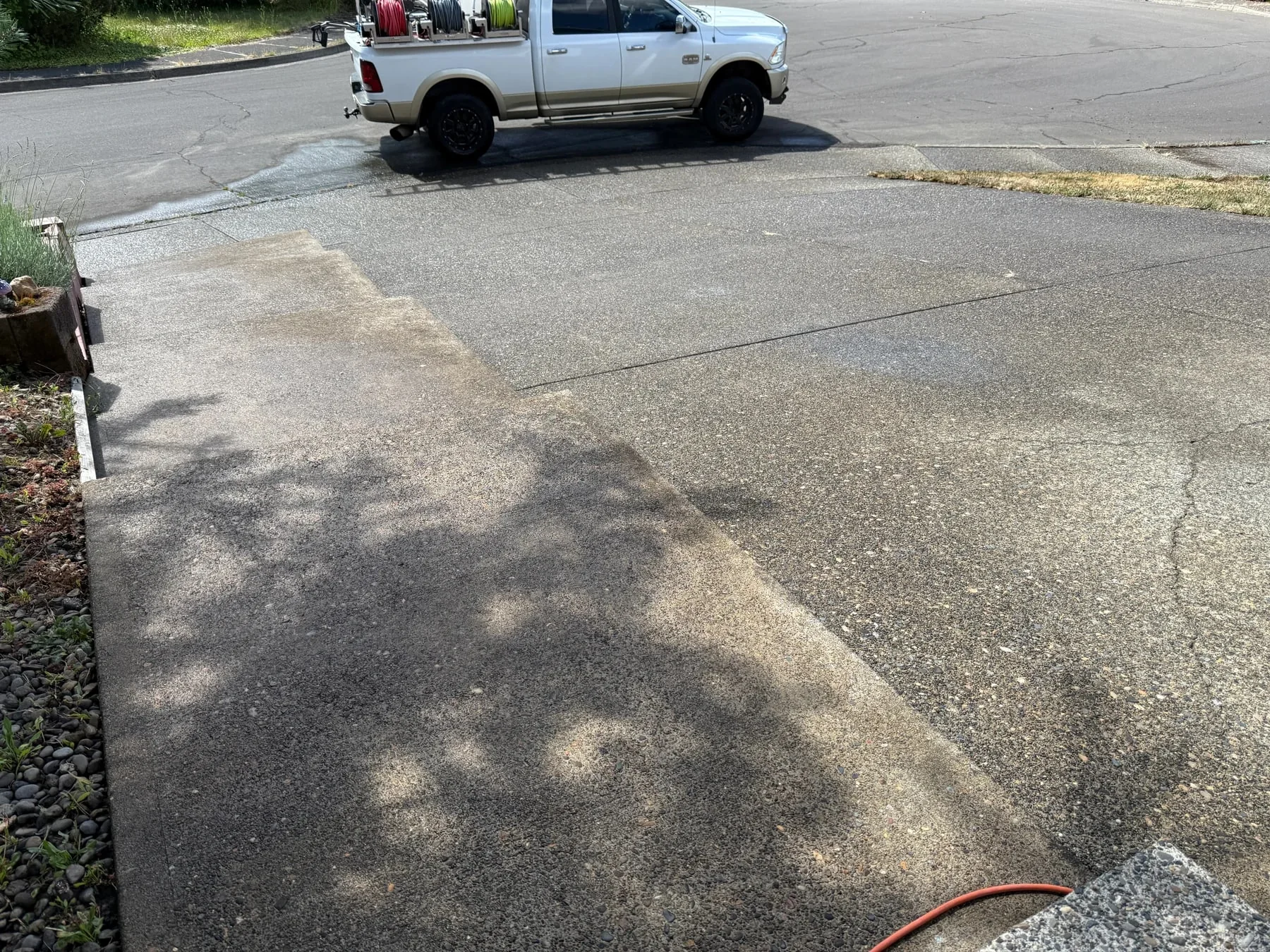Finished driveway apron and sidewalk after pressure washing with Suds Doctor truck nearby in Hillsboro