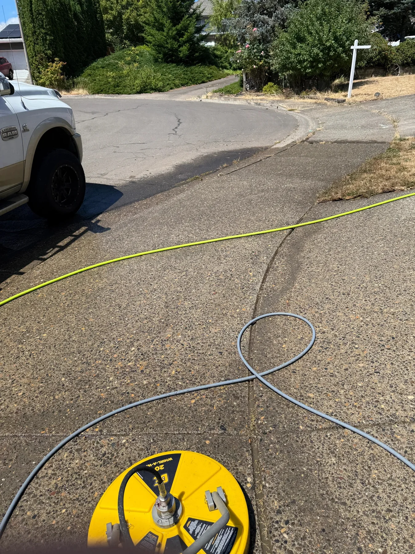 Surface cleaner in use on an exposed-aggregate Hillsboro driveway after pretreatment