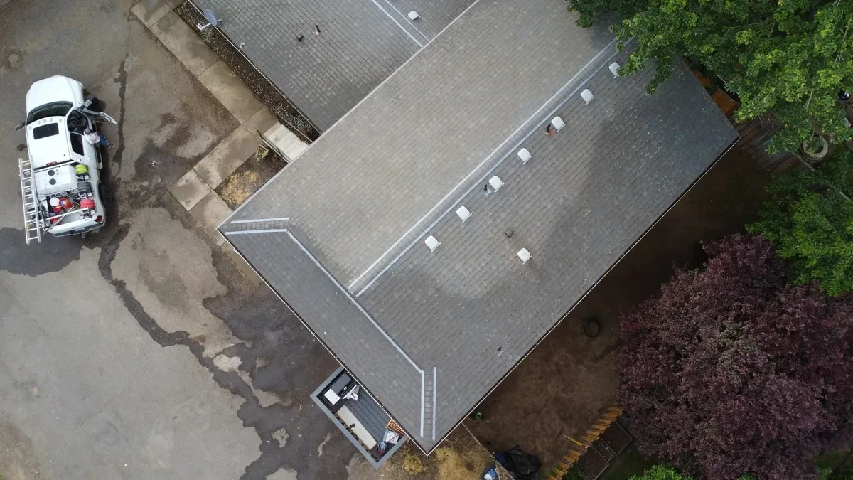 Aerial view of a Hillsboro multifamily roof and Suds Doctor cleaning truck during the project