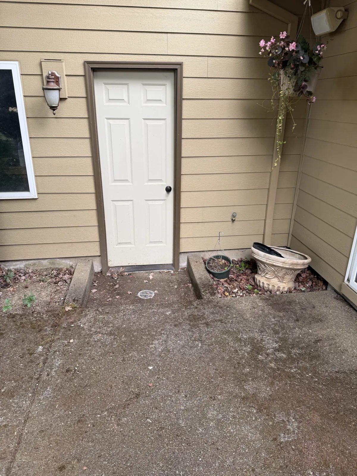 Concrete patio entry before pressure washing at a Hillsboro home