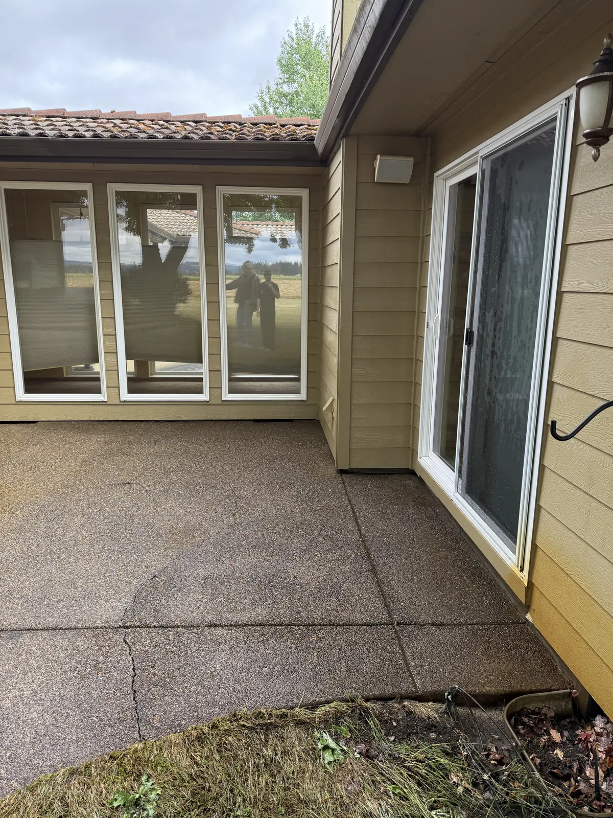 Cleaned Hillsboro patio beside windows and sliding glass door after pressure washing