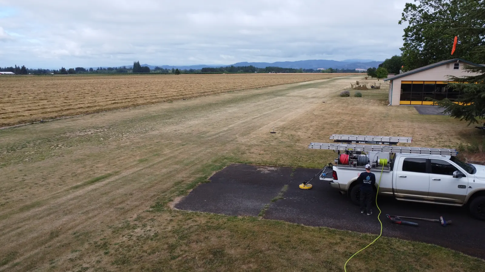 Aerial view of Suds Doctor pressure washing setup near an airstrip in Hillsboro Oregon