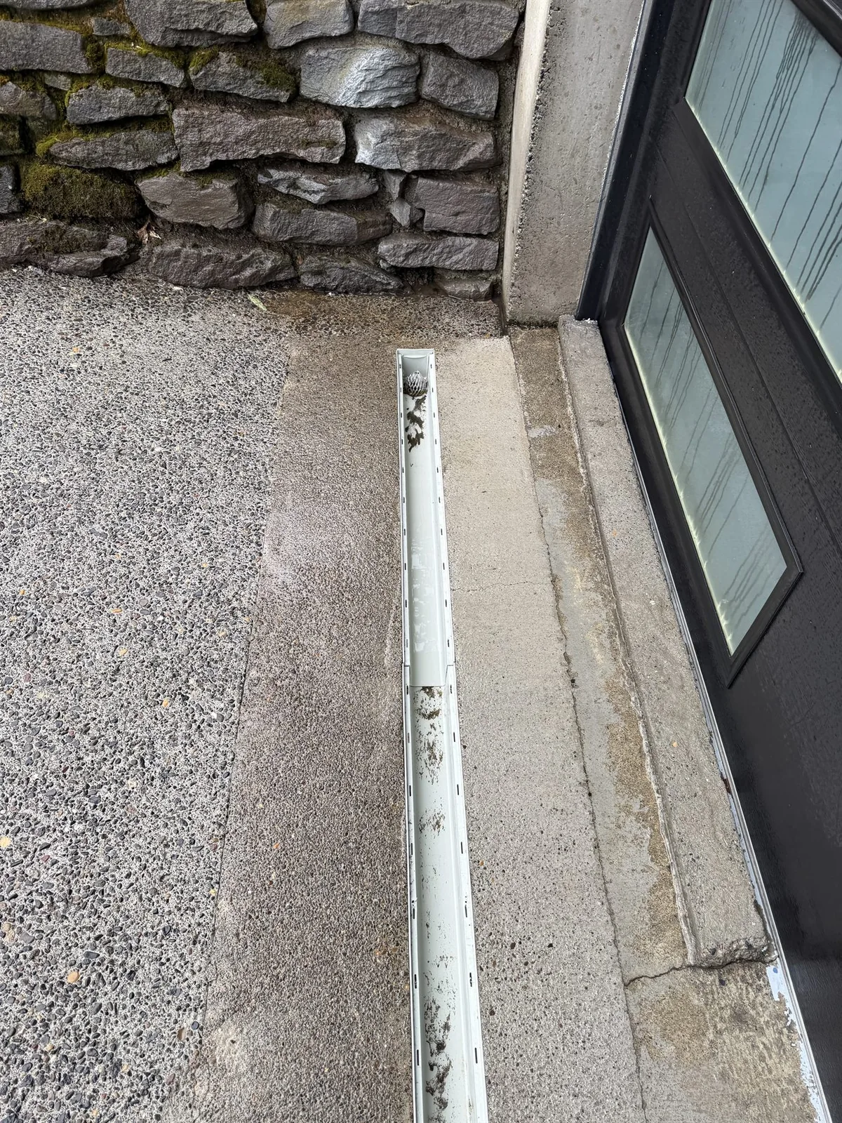 Driveway trench drain cleaned carefully during pressure washing in Portland Oregon