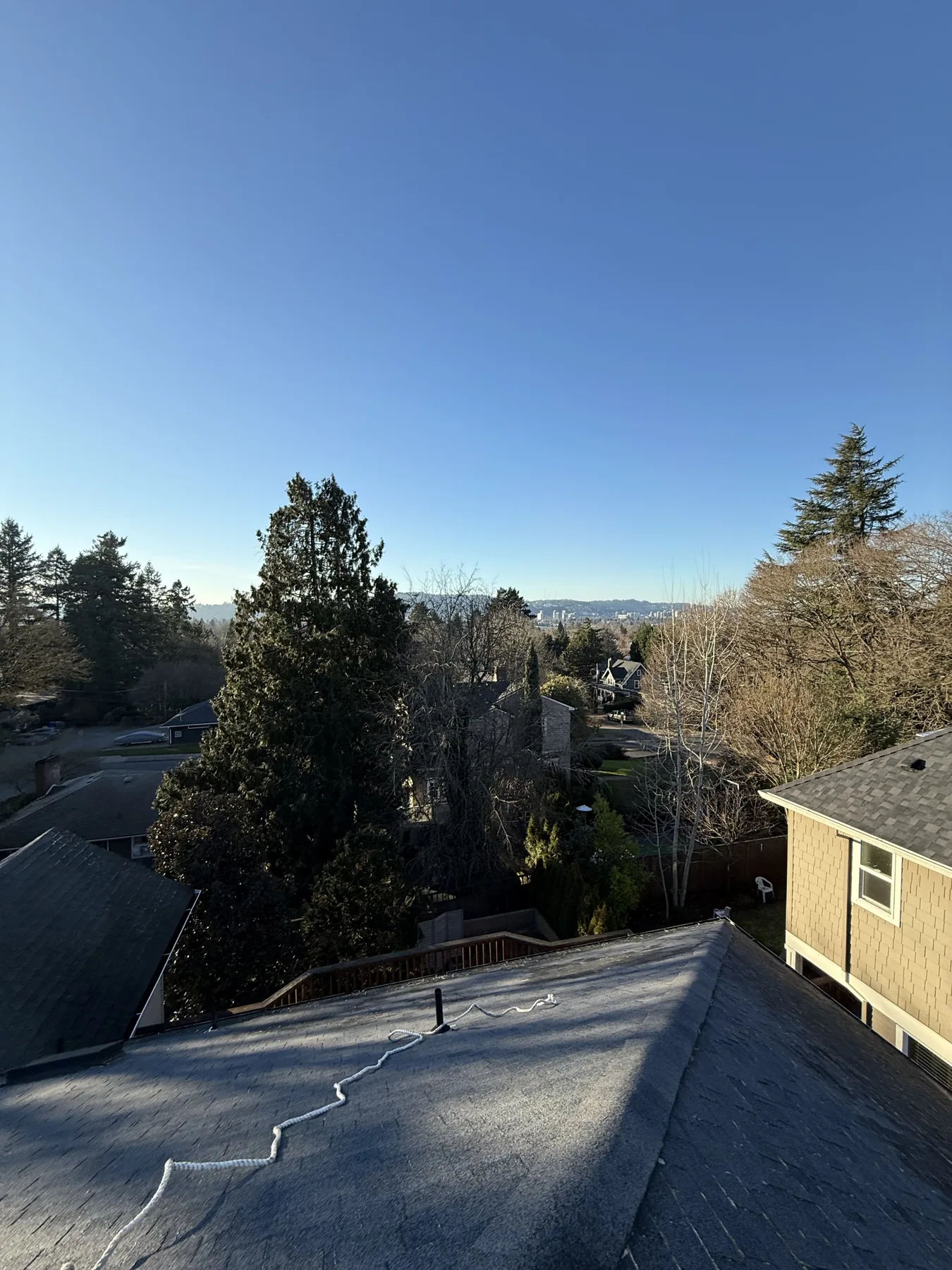 Roof treatment hose set up on a Portland asphalt shingle roof