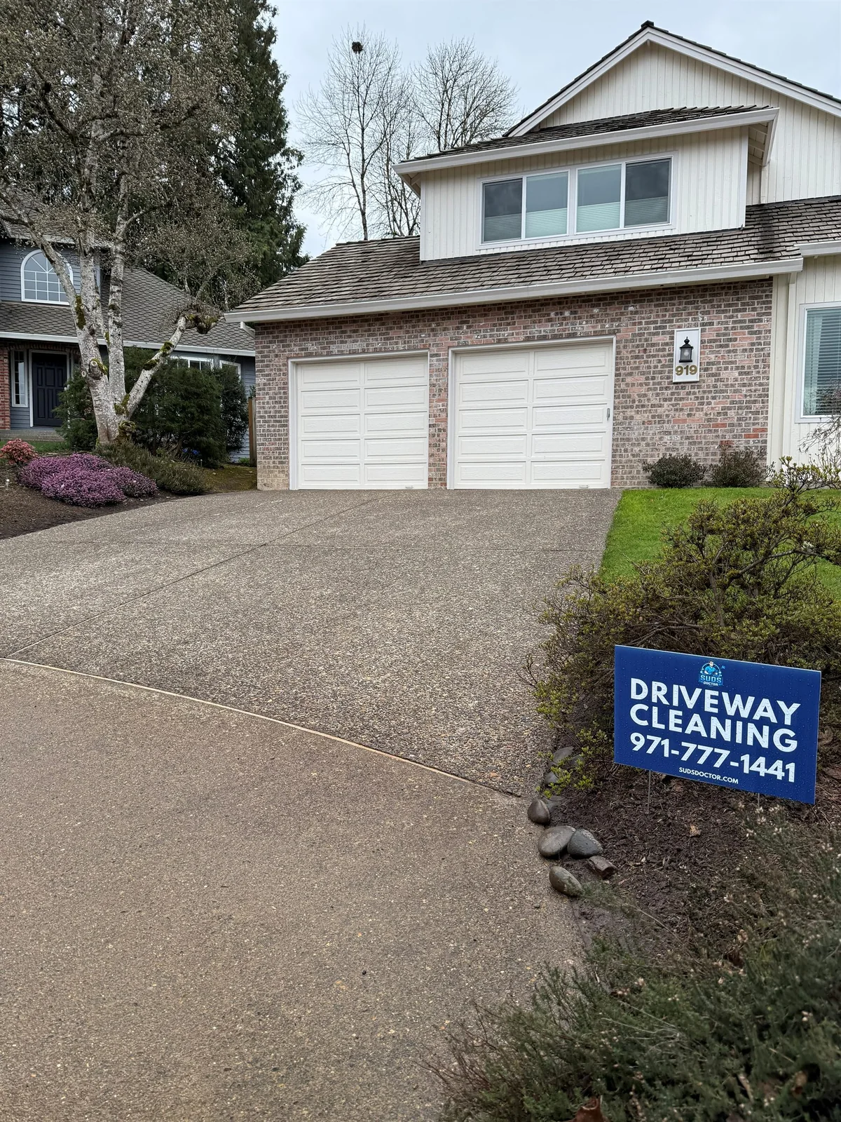 Mossy exposed aggregate driveway before cleaning in Beaverton's Five Oaks neighborhood