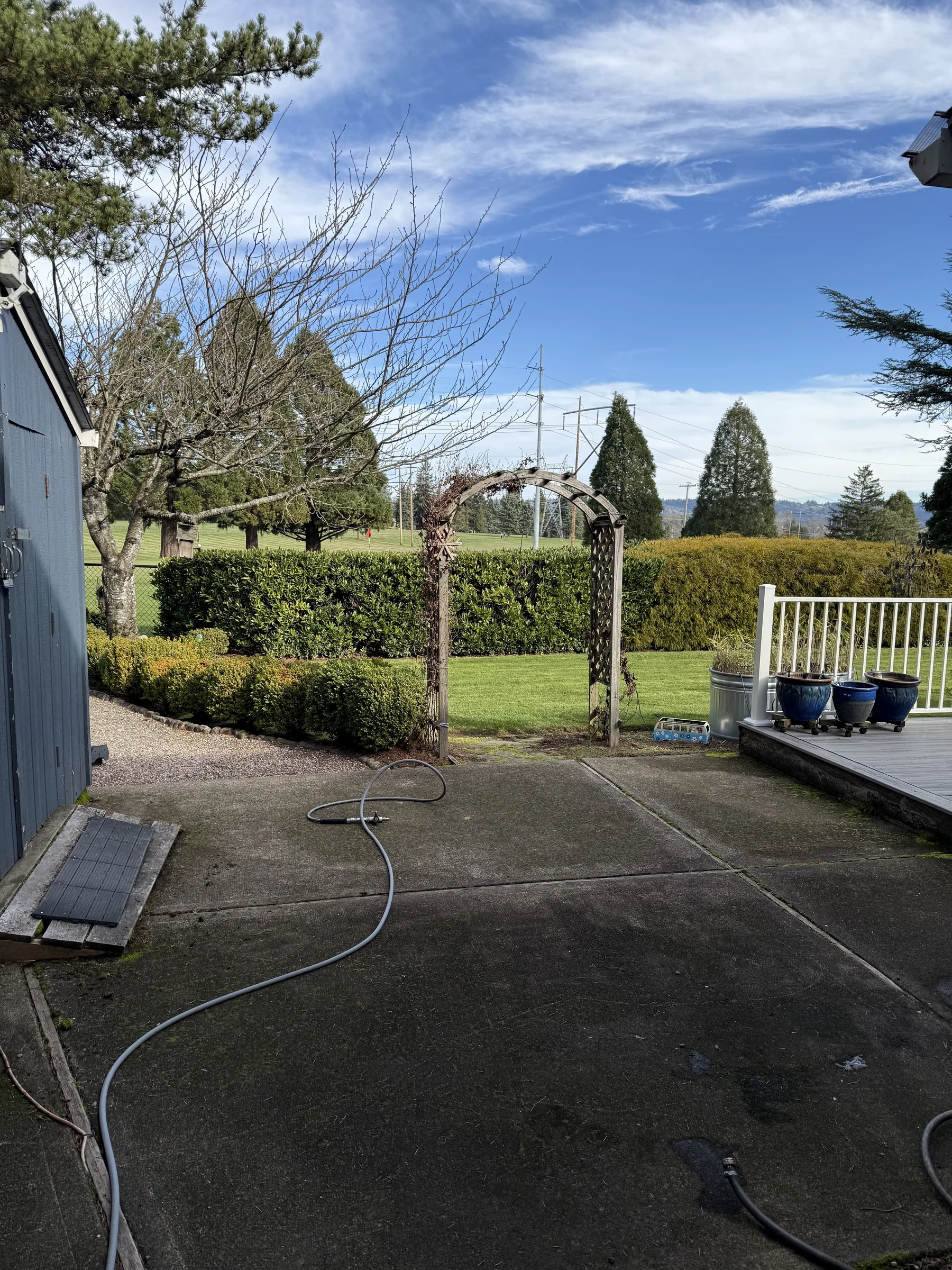 Back patio concrete before pressure washing at a Rock Creek home