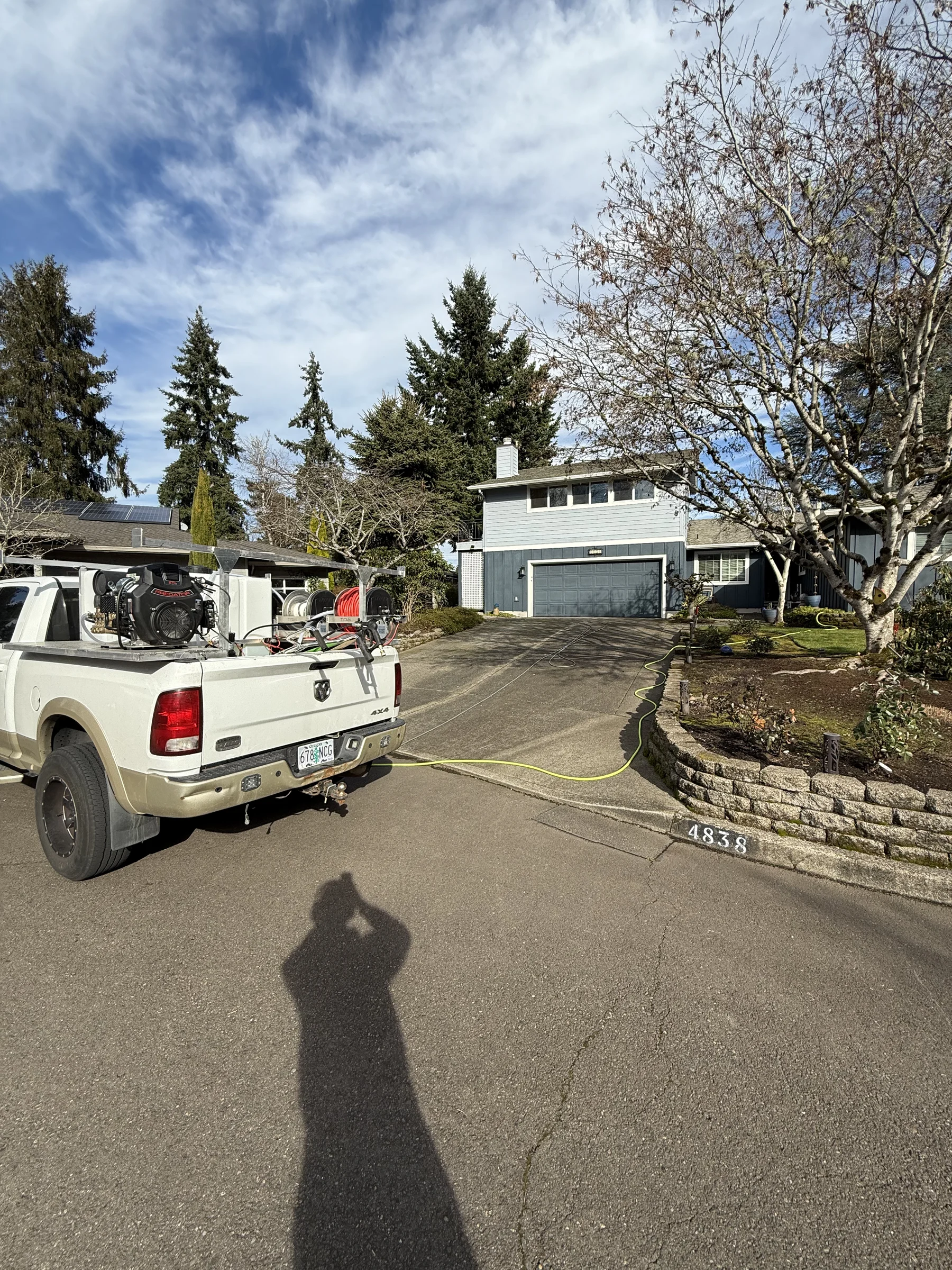 Suds Doctor truck set up for driveway pressure washing at a Rock Creek home