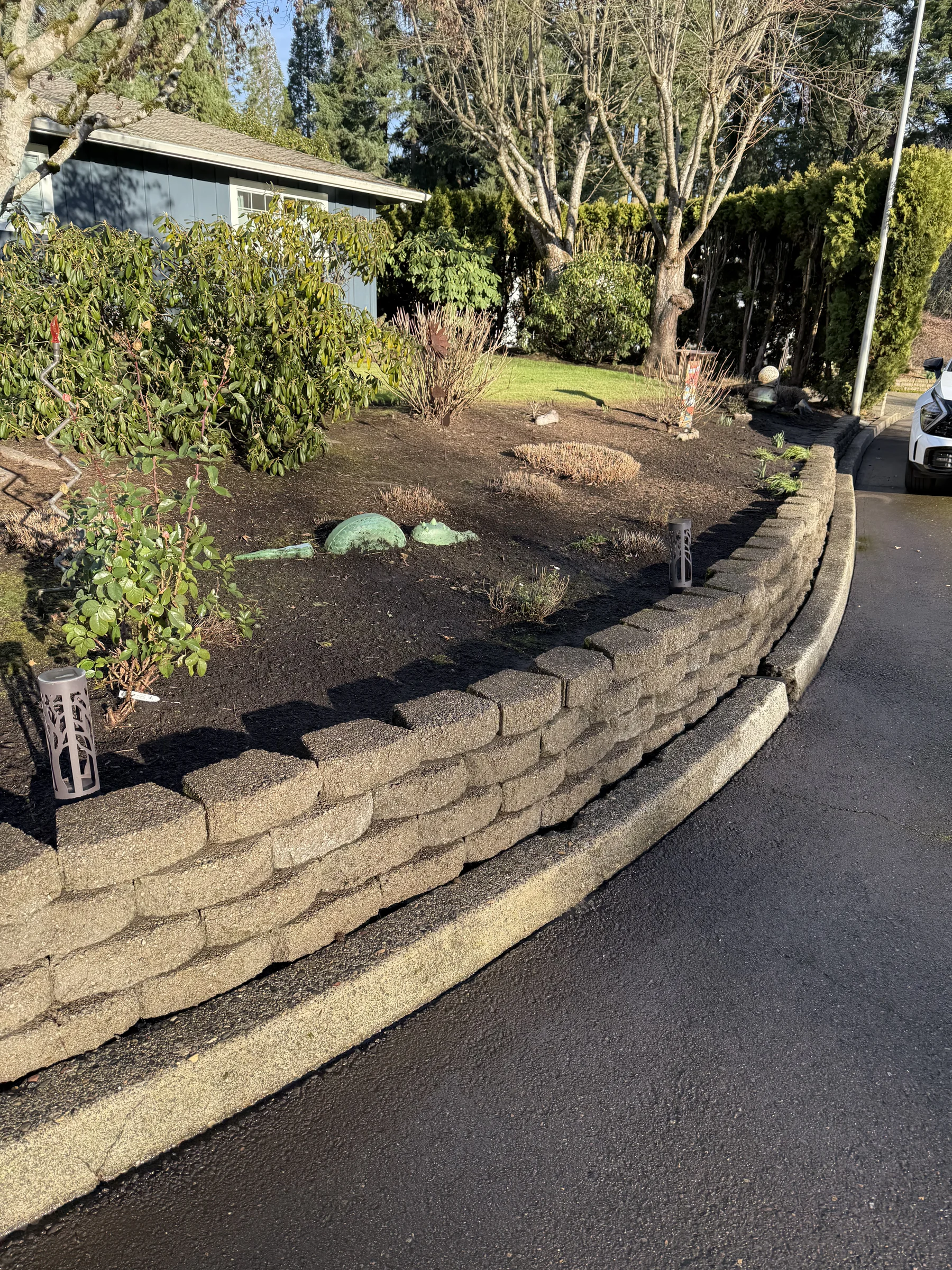 Cleaned block retaining wall beside a Rock Creek driveway