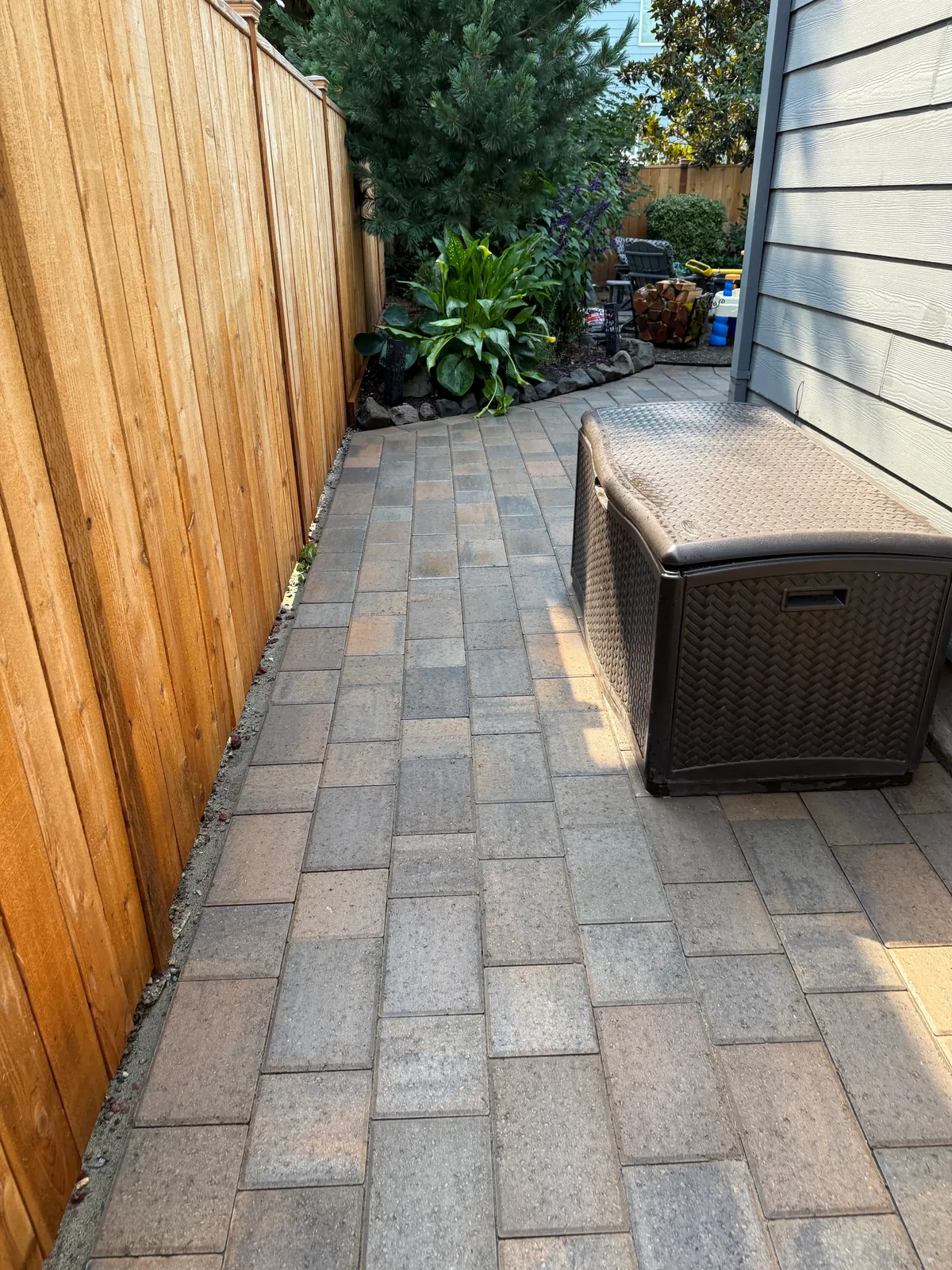 Clean pavers leading toward the backyard patio after pressure washing in Sherwood