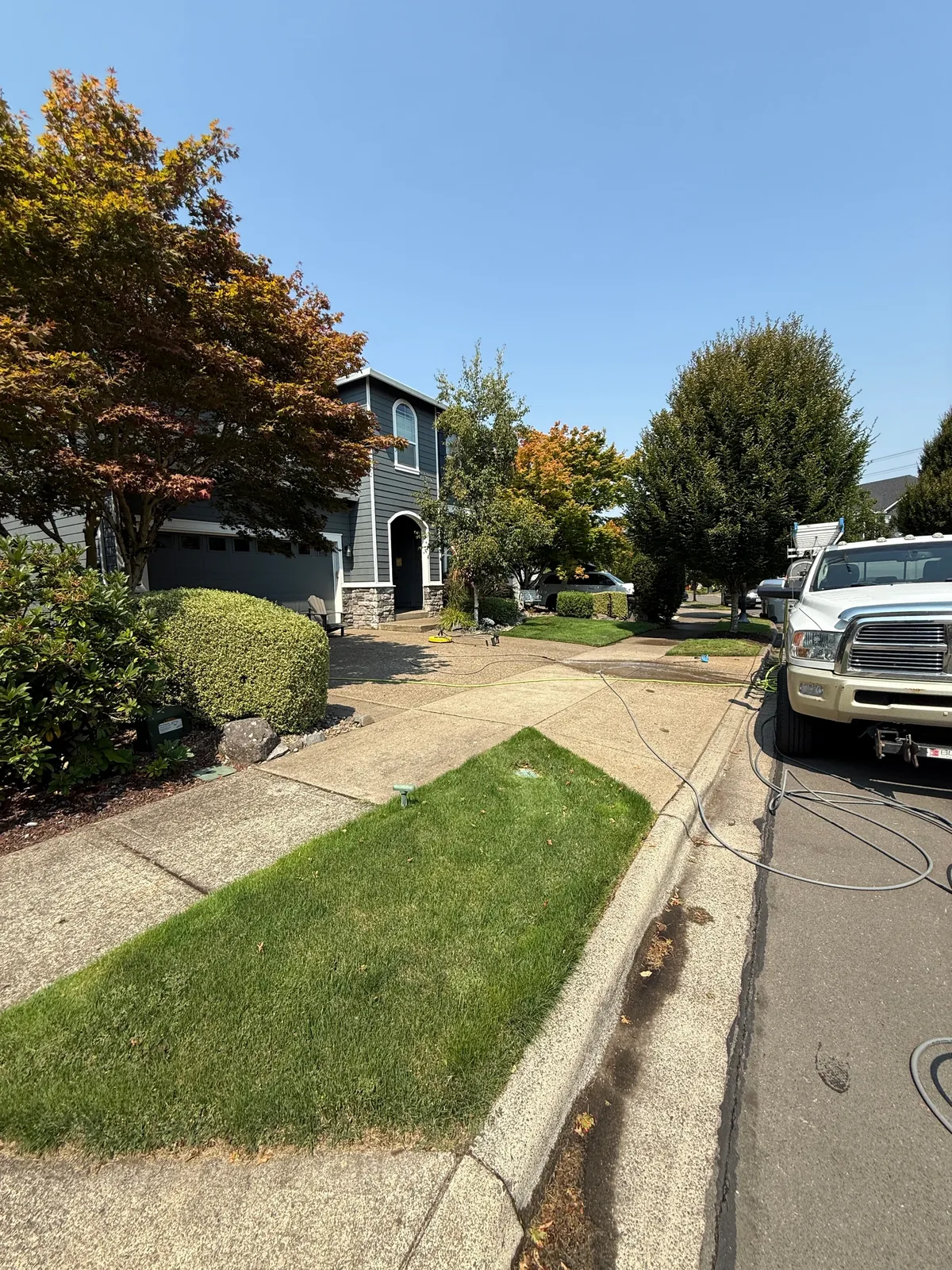 Sherwood driveway, sidewalk, and front entrance during a pressure washing project
