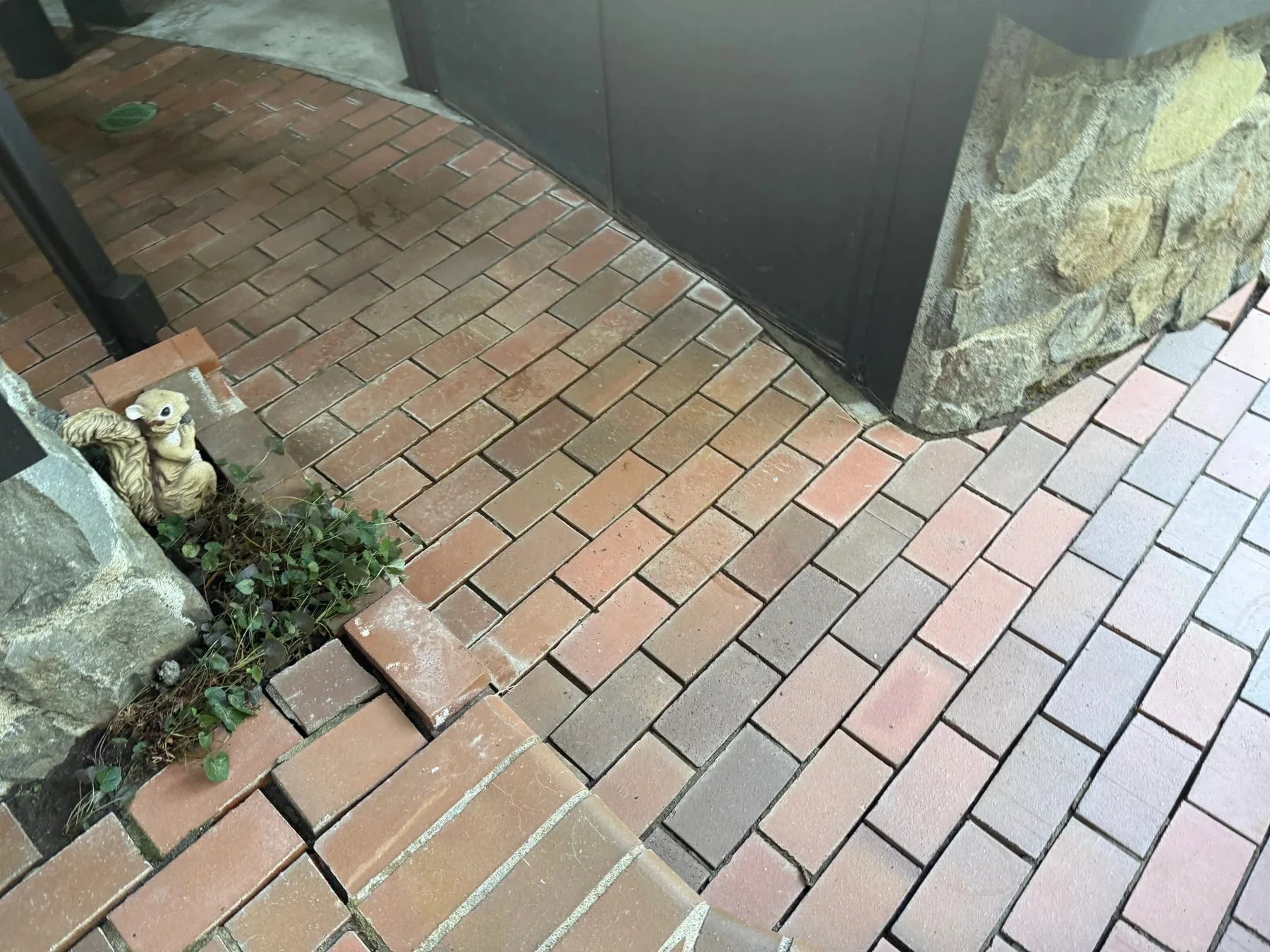 Cleaned brick floor beside the stone outdoor kitchen