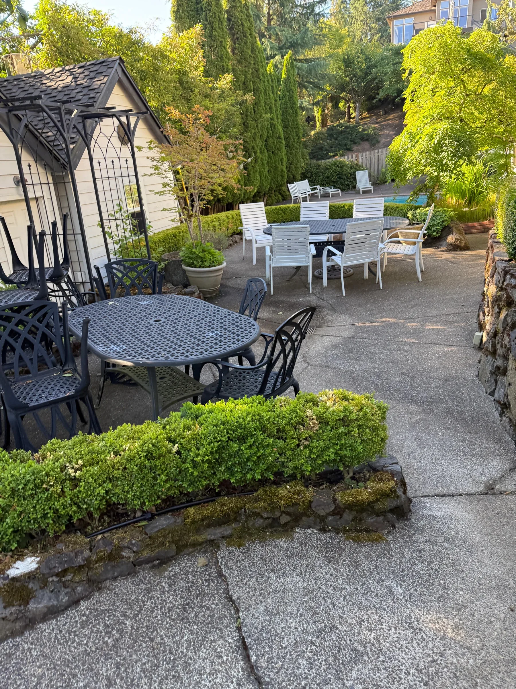 Cleaned concrete patio dining area overlooking a West Beaverton pool