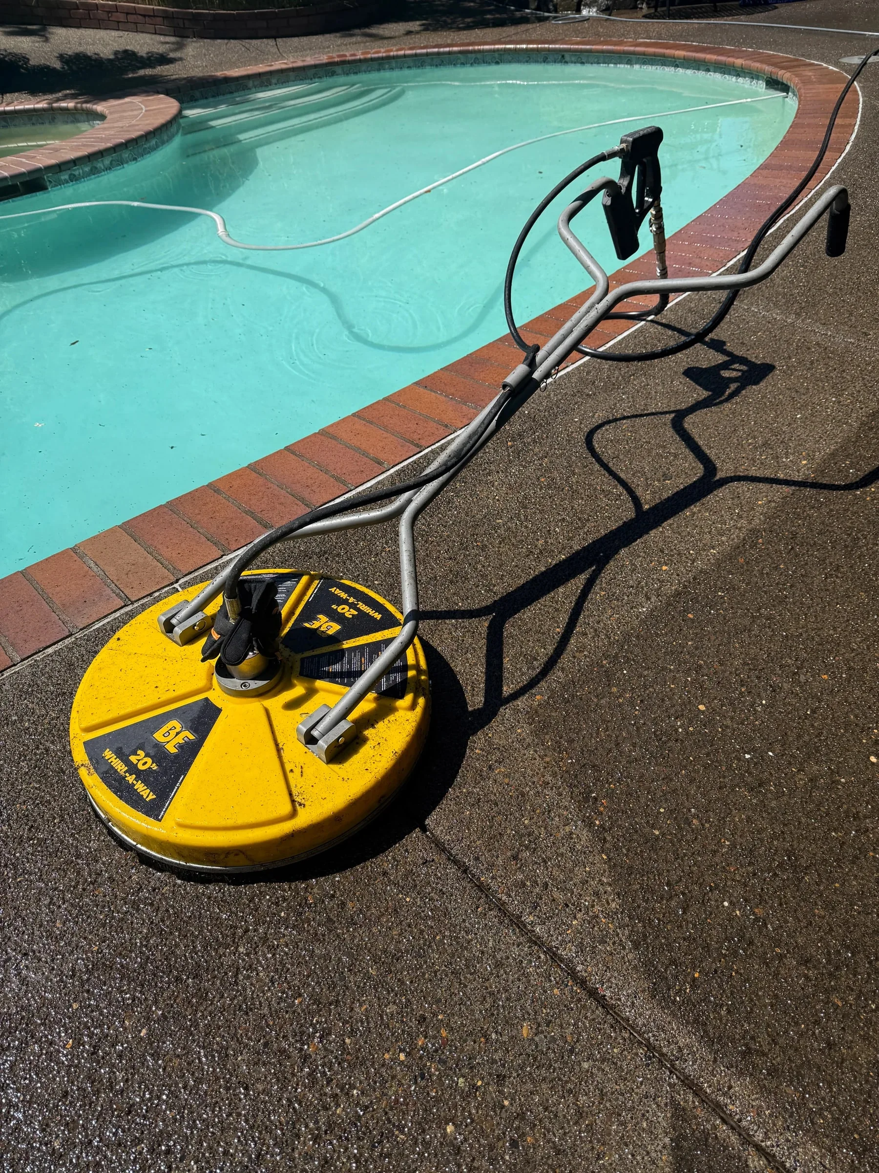 Surface-cleaning equipment positioned along the curved pool deck edge