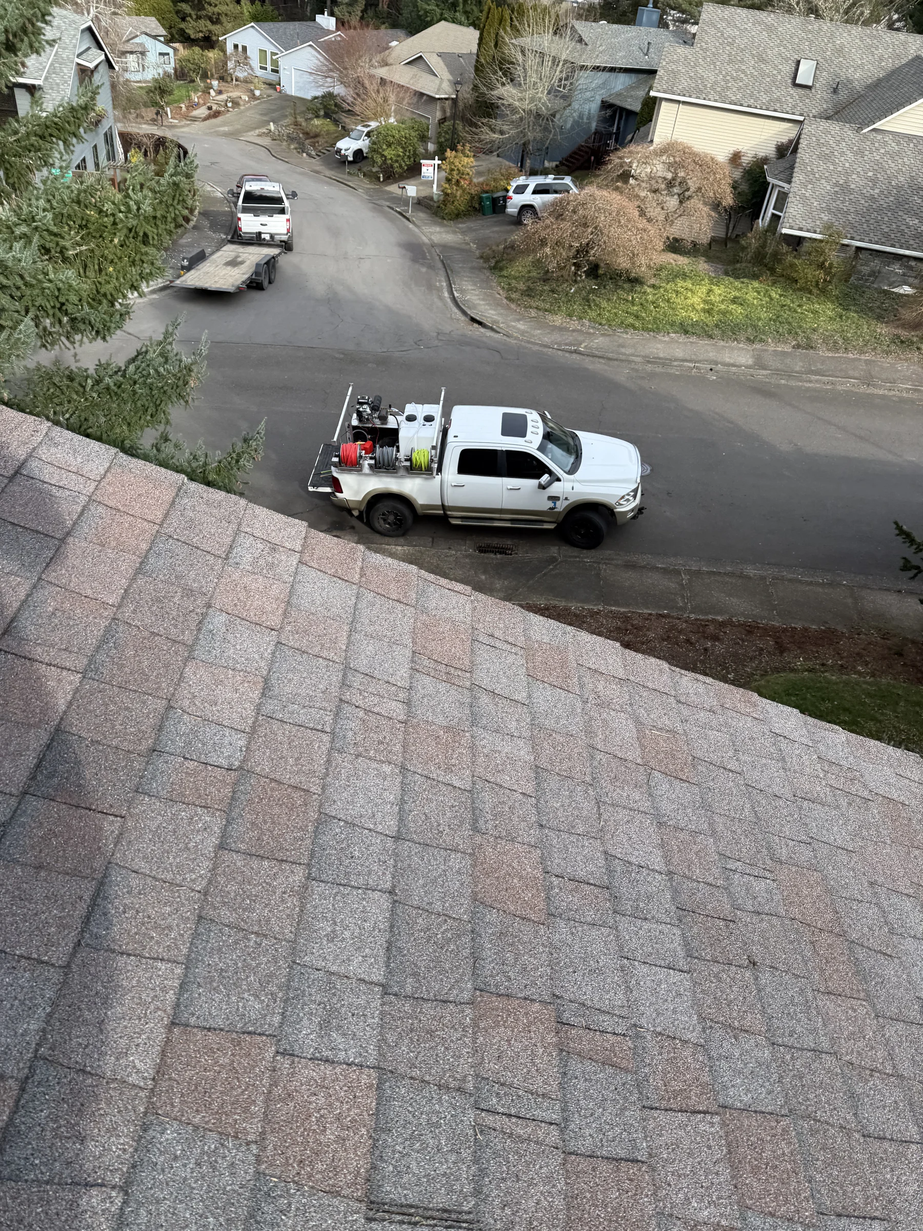 Suds Doctor truck below a West Beaverton roof during roof cleaning and gutter cleaning